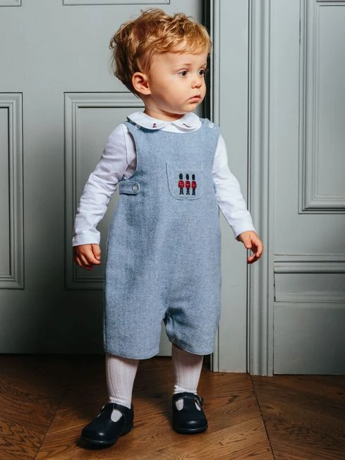 Trotters London Little Pale Blue Herringbone Archie Guardsman Romper 1 Trotters London Little Pale Blue Herringbone Archie Guardsman Romper